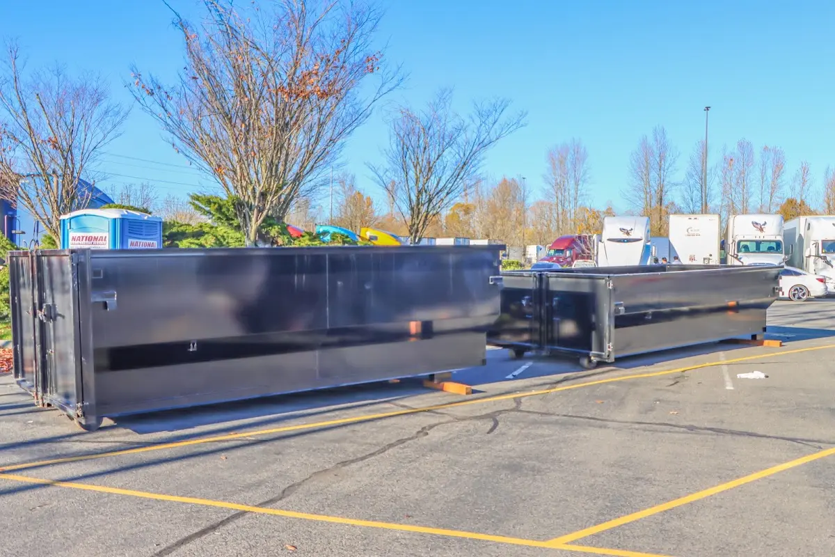 Professional dumpster rental service with roll-off container on residential driveway in Ridgefield